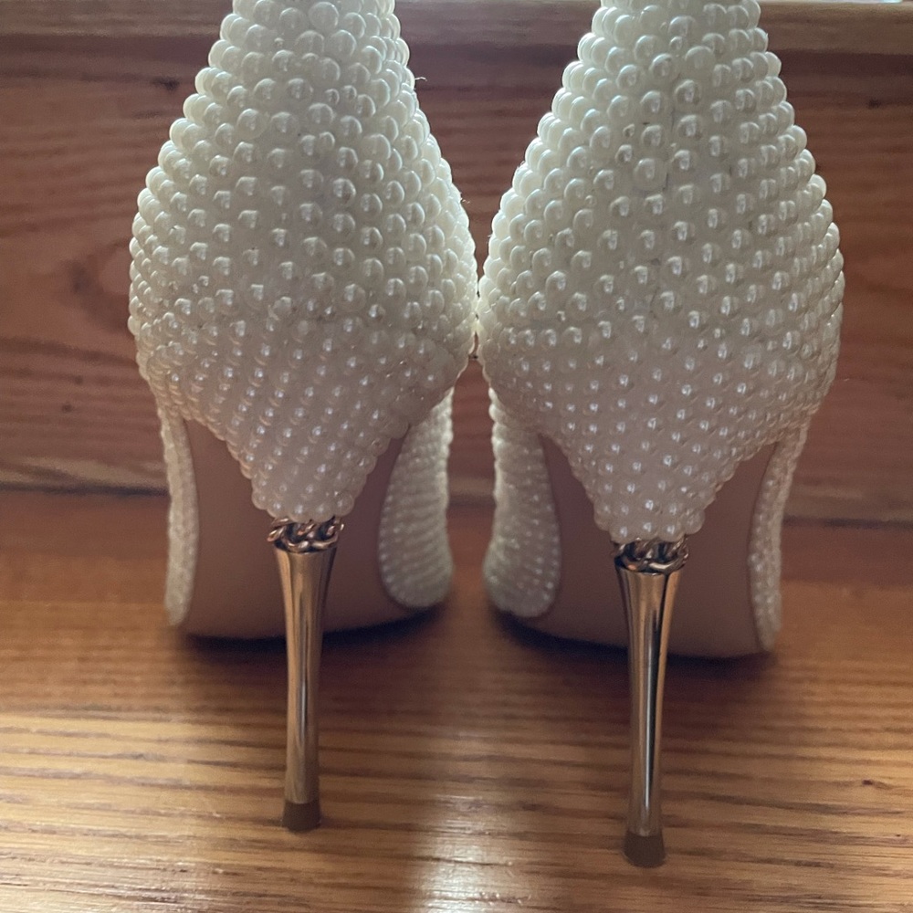Women’s white pearl coated heel shoes.